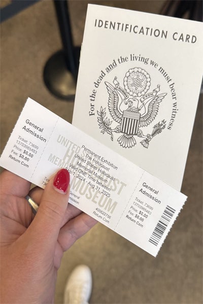 Image of a woman holding a ticket for the Holocaust museum in Washington D.C.