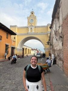 Stephanie standing in front of an ornate yellow archway.